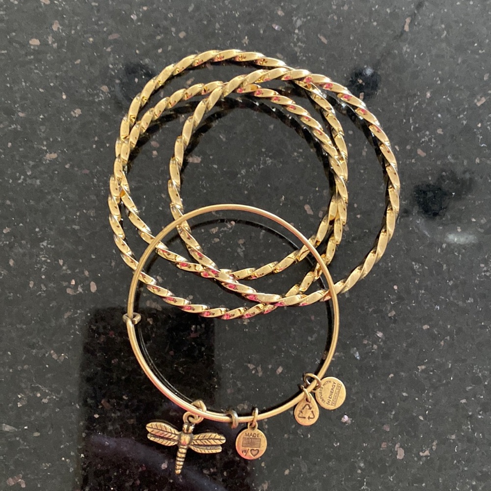 Set of gold bangles including Alex and Ani